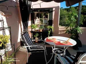 a patio with a table and chairs on a balcony at Moulin de Cot in Clermont-lʼHérault