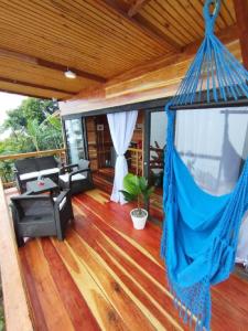 a porch with a hammock on a house at El Refugio in Quindío