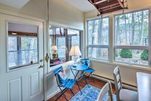 Una habitación con una mesa y sillas y ventanas. en Waterfront Retreat with Boat Dock and Fire Pit!, en Southbury