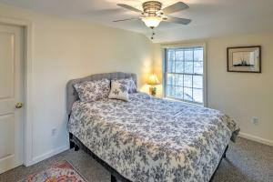 a bedroom with a bed and a ceiling fan at Waterfront Retreat with Boat Dock and Fire Pit! in Southbury