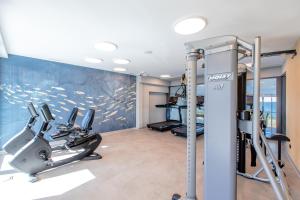 a gym with treadmills and cardio equipment in a room at Resort HEVENIA Rewal 5 in Rewal