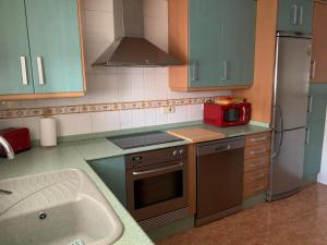 Kuchyň nebo kuchyňský kout v ubytování Apartamento Sanchiz