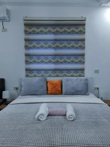 a bedroom with a large bed with two pillows at Full panorama Jerash (PLUS) in Jerash