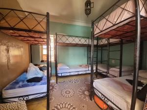 a room with three bunk beds in it at Riad Dia in Marrakesh