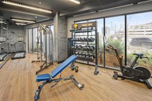 a gym with several treadmills and exercise equipment at Global Luxury Suites at Tribeca in Washington, D.C.