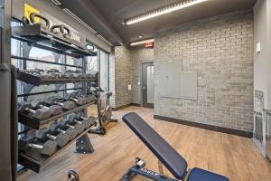 a gym with a brick wall at Global Luxury Suites at Tribeca in Washington, D.C.