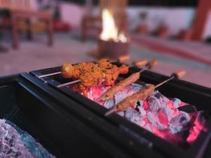 a bunch of food cooking on a grill at SH SUNSET RESORT in Nainital