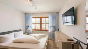 a living room with a couch and a tv at Ferienwohnung Elisabeth in Pfronten