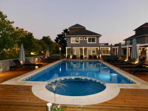a swimming pool in front of a house at Torrecillas Carilo in Carilo
