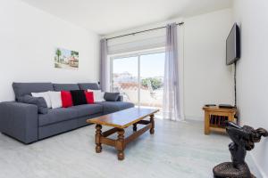 a living room with a couch and a coffee table at Fabrica da Ribeira Apartment by Seewest in Lagos