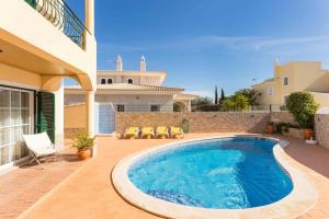 a swimming pool in front of a house at Sunflower Villa by Seewest in Lagos