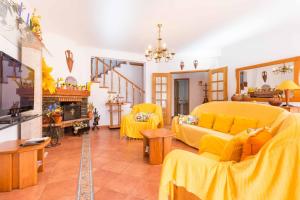 a living room with yellow furniture and a yellow couch at Sunflower Villa by Seewest in Lagos