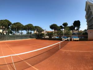 a tennis court with a net on top of it at Hotel Franca in Milano Marittima