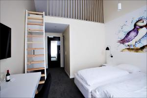a bedroom with two beds and a ladder at Hotel Hafnia in Tórshavn