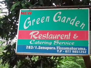 a sign for a green garden and restaurant and catering service at New Green Garden Hotel & Safari in Tissamaharama