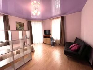 リヴィウにある3 кім квартира по вулиці Котлярська біля Оперного театруの紫の壁のリビングルーム(ソファ付)