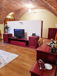 a living room with a flat screen tv in a room at Penzión pod kláštorom in Pezinok