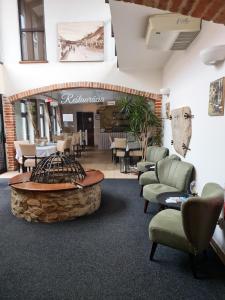 a waiting room with chairs and a fire pit at Penzión pod kláštorom in Pezinok