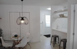 a dining room with a glass table and chairs at Condo En Quatre Temps in Beaupré