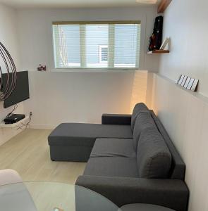 a living room with a couch and a window at Condo En Quatre Temps in Beaupré