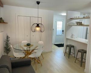 a dining room and kitchen with a glass table and chairs at Condo En Quatre Temps in Beaupré