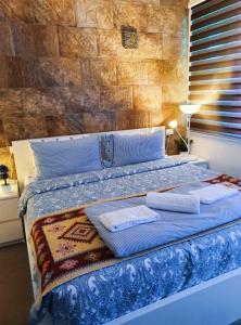 a bedroom with a bed with towels on it at Full Panorama To Archaeological Site Jarash in Jerash