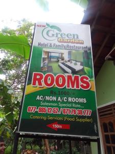 a sign for a house with a sign for rooms at New Green Garden Hotel & Safari in Tissamaharama