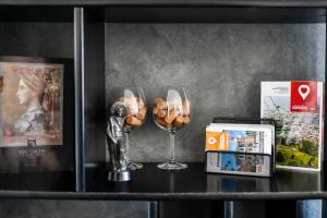 a table with two wine glasses and a statue at 2 bedroom Penthouse in city center, free parking in Sarajevo