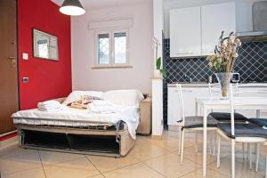 a room with a bed and a table and a kitchen at B&Bea sweet home Aurelia in Rome