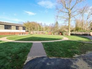 a walkway in a grassy yard with a building at The Granary in Norwich