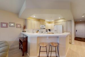 a kitchen with two bar stools and a counter top at Mountain Lake Getaway (B101) in Twin Beaches