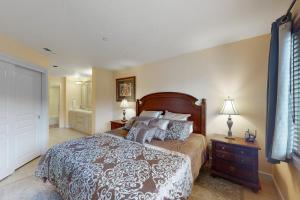 a bedroom with a large bed and a bathroom at Mountain Lake Getaway (B101) in Twin Beaches
