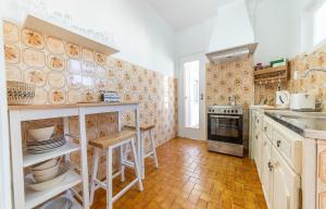 a kitchen with white cabinets and a stove top oven at Abrotea Apartments in Lagos