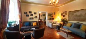 a living room with a blue couch and chairs at Hôtel Le Siècle in Mazan