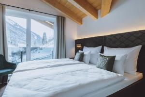 Ein Bett oder Betten in einem Zimmer der Unterkunft Glemm by AvenidA Hotel & Residences Hinterglemm