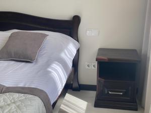 a bedroom with a bed with a nightstand and a bed sidx sidx at Sun Lidia in Chernivtsi