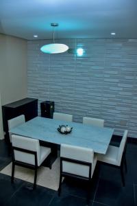 a dining room table with chairs and a blue light at Beautiful Town House in Lagos