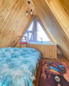 a bedroom with a bed and a sink in a attic at Yalova Kasaba Bungalov in Çınarcık
