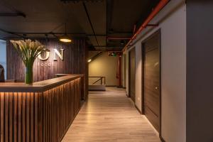 a hallway with a counter with a vase of flowers at Bon 17 Hotel By SHG in Bogotá