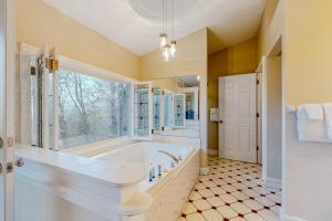 a large bathroom with a tub and a window at Ozark Spring Cabins - Mountain View 01 in Eureka Springs