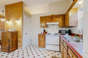 a kitchen with wooden cabinets and a white stove top oven at Ozark Spring Cabins - Mountain View 01 in Eureka Springs
