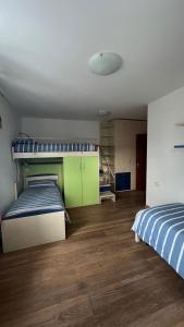 1 dormitorio con 2 camas y suelo de madera en Al Bel VEDER en Levico Terme