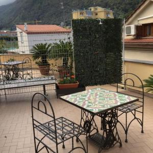 einen Tisch und Stühle auf einer Terrasse in der Unterkunft Sorrento Penthouse Suites in Sant'Agnello