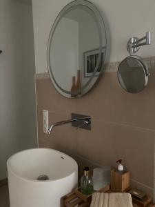 a bathroom with a white tub and a mirror at Auszeit am Haffufer in Wilhelmshof