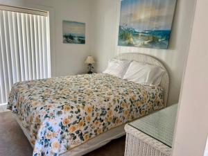 a bedroom with a bed with a comforter on it at Sea Club I in Longboat Key
