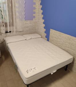 a bed in a room with a white mattress at Cozy home in Pertegada