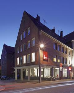 a large brick building on a street corner at Hotel an der Marienkirche in Lübeck