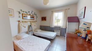 1 dormitorio con 2 camas y ventana en Villa La Grande Vallée en Saint-Gilles-Croix-de-Vie