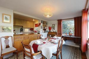 a kitchen with a table and chairs in a room at Whitestones in Brighstone