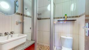 a bathroom with a shower and a toilet and a sink at San Lameer 3123 by Top Destinations Rentals in Southbroom +17 photos